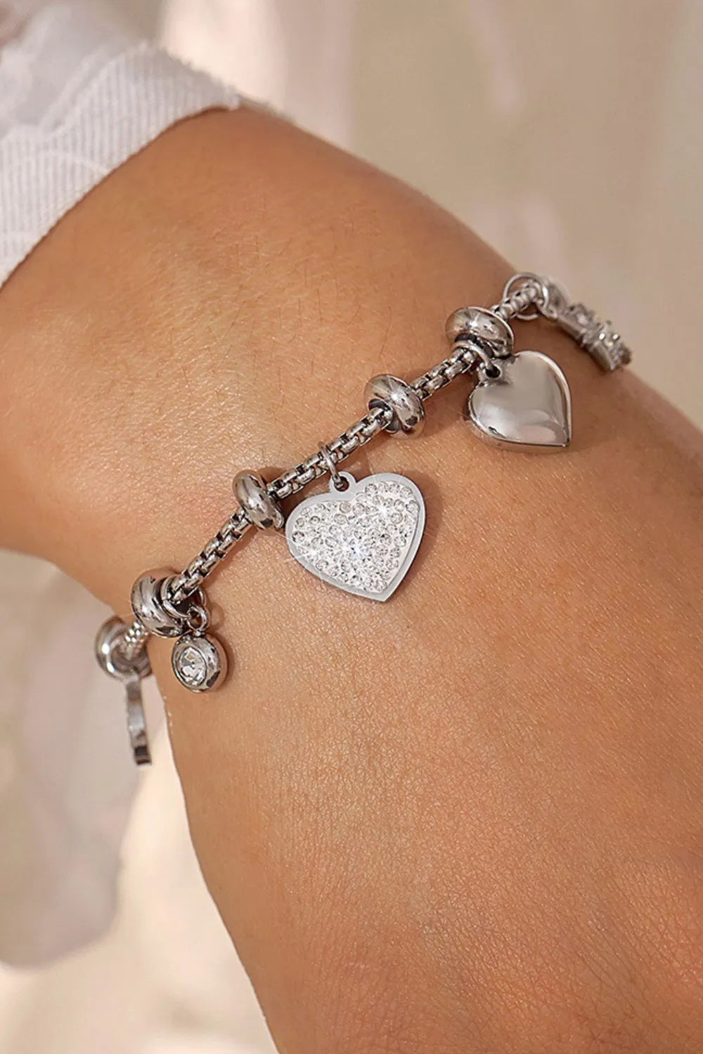 layered gold and silver charm bracelets styled for summer